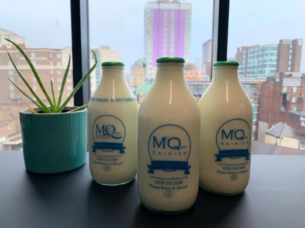 Glass milk bottles against window