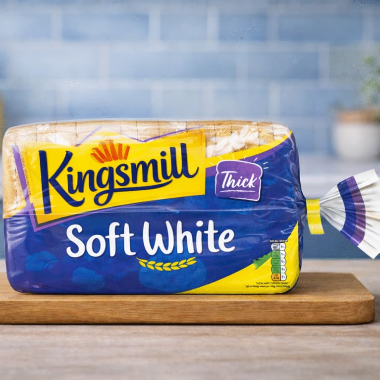 Kingsmill Soft White thick sliced bread on wooden board in kitchen setting